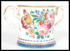 A 19th century Victorian loving cup with hand painted floral detailing, footed base, scrolled leaf