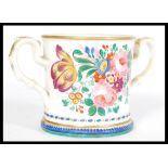 A 19th century Victorian loving cup with hand painted floral detailing, footed base, scrolled leaf