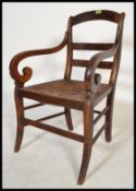A 19th century Regency mahogany framed carved chair / armchair., Rattan seat pad with carved arm