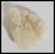 A 19th century Chinese carved white jade figurine group depicting an elder and child. measures: 4.