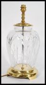 A  Waterford crystal  lead cut glass table lamp raised on a brass rounded pedestal having a