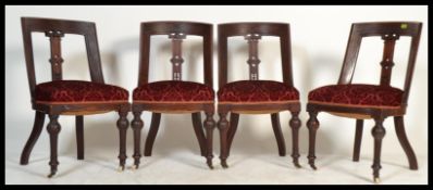 A set of four 19th century Victorian Aesthetic movement mahogany dining chairs on ceramic castors