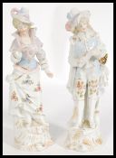 A pair of 19th century continental German figurines numbered 6 and 32, depicting a gentleman and