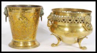 A pair of 19th century brass planters with lion ring handles, one raised on three paw feet with