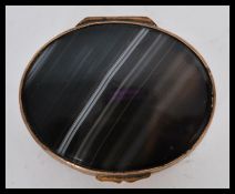 A 19th century Scottish banded agate pill box of gilt brass construction and a black and white