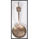 A rare early 20th century silver hallmarked London import silver caddy spoon with Dutch scenes and