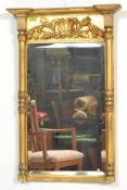 A 19th Century Regency giltwood pier glass / mirror, with painted panel above a rectangular plate