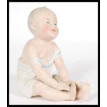 A 19th Century Continental bisque ceramic Piano Baby figurine, stamped 28 to the base, please see