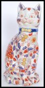 A large 20th Century Chinese ceramic enlightened lucky cat, decorated in a pattern of lotus and