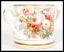 A early 19th century loving cup circa 1820 with twin handles having a plinth base, hand painted