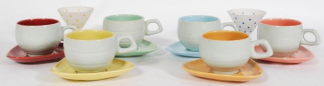 A collection of vintage retro mid 20th century tea cups and saucers with coloured interiors and