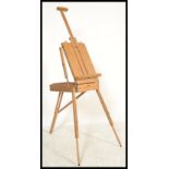 A 20th century artists collapsible easel box with three extendable legs and adjustable easel