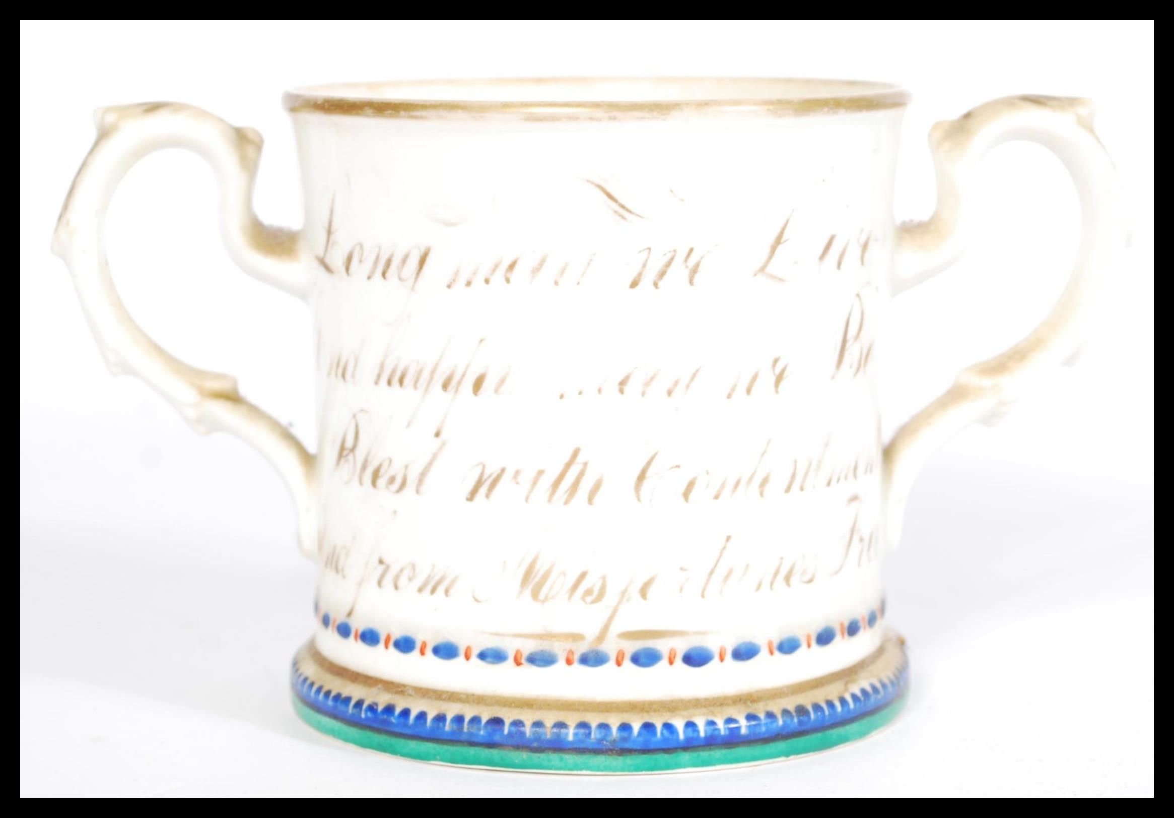 A 19th century Victorian loving cup with hand painted floral detailing, footed base, scrolled leaf - Image 2 of 4