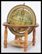 A vintage 20th century wooden desk top globe having zodiac symbol ring to the stand. measures:
