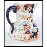 A 19th century large Masons jug having a chinoiserie pattern featuring peony flowers, shaping to the