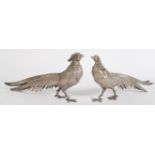 A pair of 20th century silver plated pheasant ornaments featuring a male and a female with lengthy