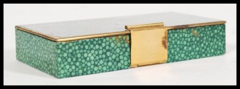 A vintage retro mid 20th century brass compact with faux shagreen effect to the exterior having