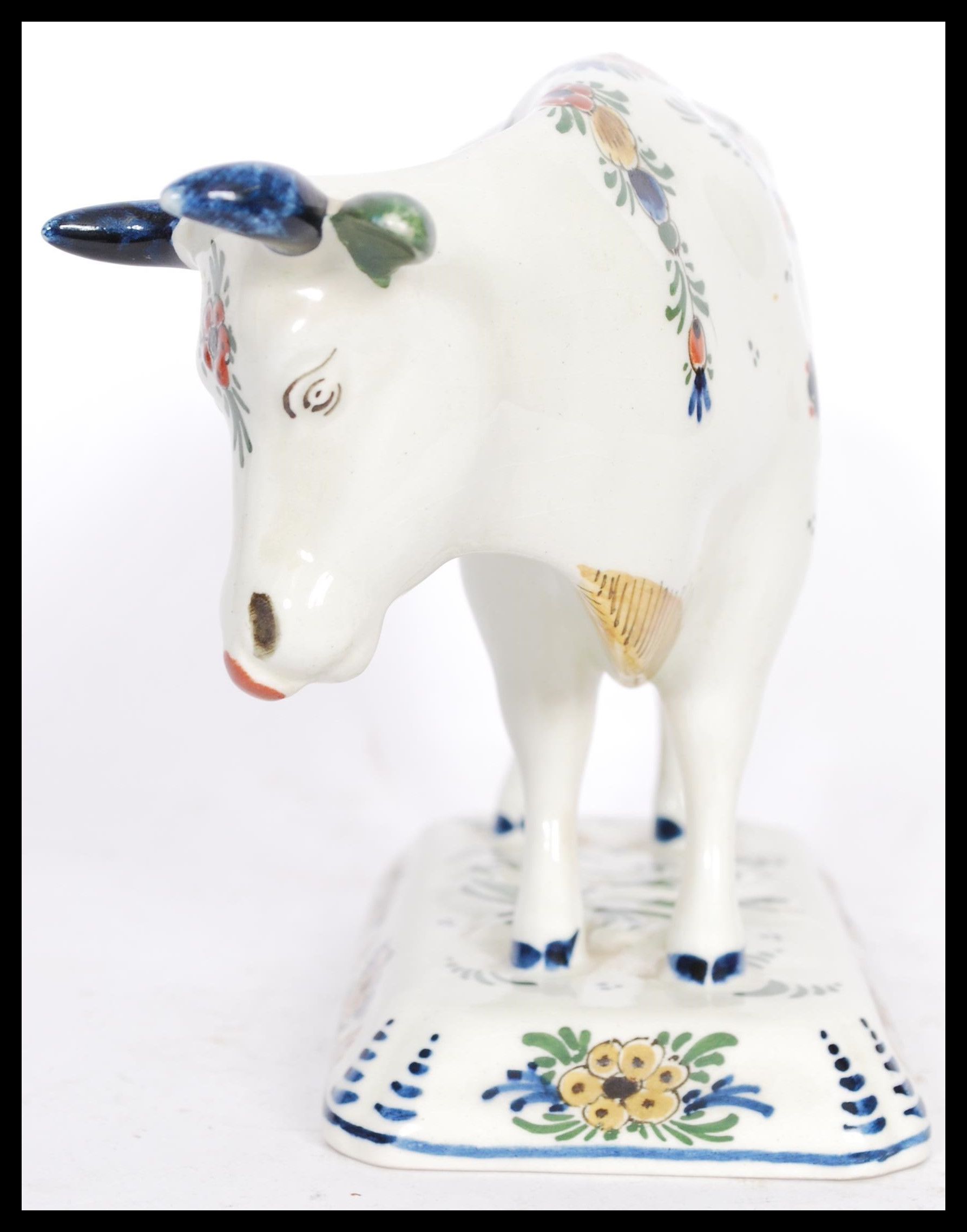 A 19th / 20th Century Delft ceramic figurine of a cow having hand painted floral sprays with painted - Image 2 of 8