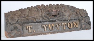 A 19th century Burmese name plaque with inscription T. Tutton having carved detailing of a Chinese