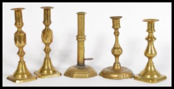 A group of 19th century brass candle sticks to include a pair of Victorian queen of diamond