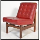 A 1970's retro vintage easy lounge chair / armchair comprising of a button backed crimson red