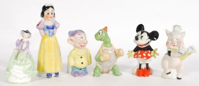 A group of ceramic vintage 20th century retro Disney toothbrush holder figurines to include Snow