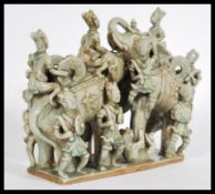A 20th century Asian Cambodian ceramic figure group with a mint crackle glaze on a rectangular