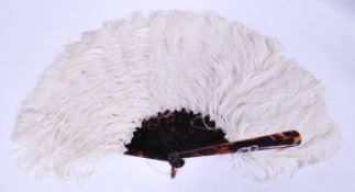 A vintage early 20th century ostrich feather and tortoiseshell handled hand fan having 18 blades.