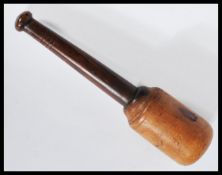 A 20th century fishing yew treen ware priest with a walnut turned tapering handle. Measures: 32.