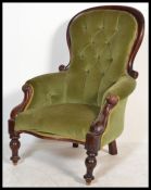 A 19th Century Victorian mahogany armchair with carved scrolling frame, raised on turned supports,