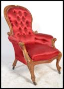 A Victorian walnut framed spoon back easy chair wi