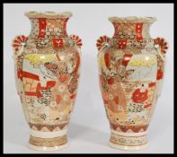 A pair of 20th century satsuma ware Japanese kutani vases with hand painted courting figures