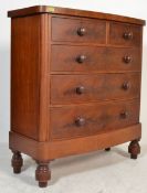 A Victorian mahogany large bow front chest of drawers being raised on tall bun feet with 2 short