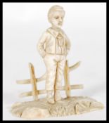 A 19th century English/ Dieppe carved ivory depicting a small boy with his hands in his pocket