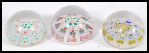 A group of three 20th century Millefiori coloured glass paper weights with two having Strathearn S