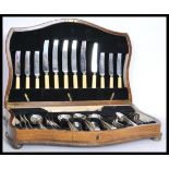 A 58 piece set of silver plated oak cased 1950's vintage cutlery canteen by Brown and Gardiner.