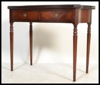 A 20th Century Regency revival mahogany tea table / games card table being raised on turned legs