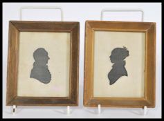 A pair of 19th Century framed and glazed silhouettes of a gentleman and a lady, signed R.P. Wills,