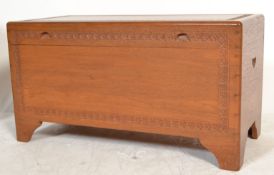 A Chinese 20th century camphor wood blanket box chest of plain form with simple carved detailed