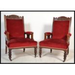 A pair of early 20th Century Edwardian button back upholstered library armchairs having red velour