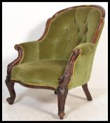 A 19th Century Victorian mahogany armchair with carved scrolling frame, cabriole legs, button back