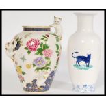 A pair of 20th century vases to include a Franklin Mint 'Vase of the imperial cats' having floral