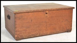 A 19th century Victorian pine blanket box coffer chest having drop handles, the hinged lid opening