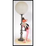 A vintage retro 20th century Pink Panther novelty lamp depicting the iconic character leaning on a