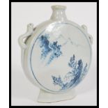 A 19th century Chinese blue and white vase of moon flask shape having hand painted details.