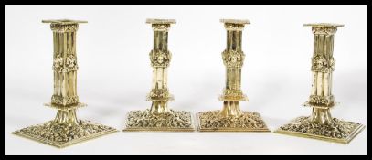 A set of four 17th century candlesticks having exquisite ornate detailing to the square bases