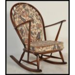 A mid 20th century Ercol beech and elm wood whelback windsor pattern rocking chair - armchair being
