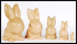 A group of 20th century ceramic SylvaC graduating rabbit figurines with a matte brown glaze, biggest