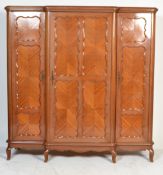 A large early 20th century breakfront triple wardrobe of provincial French origin. Of walnut