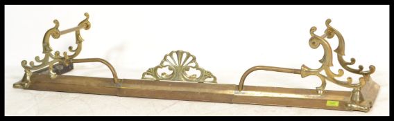 A late 19th Century Victorian Arts and Crafts brass adjustable brass fire fender, adorned with